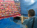 The boy take a air gun shot at Game booth winning prizes for dolls in a community fun fair. Royalty Free Stock Photo